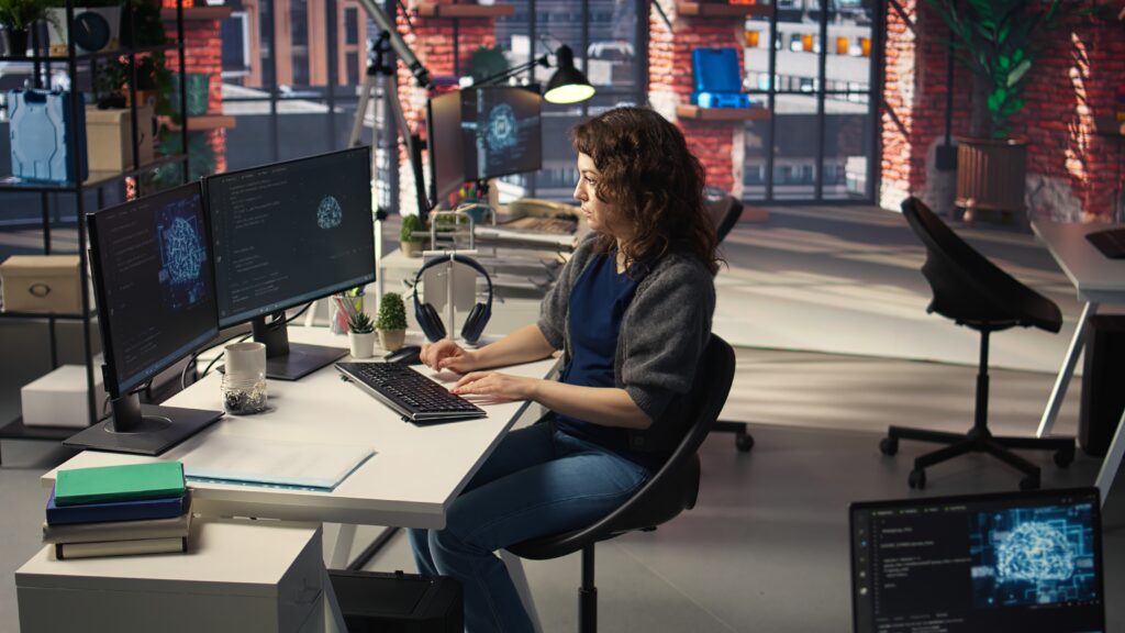 Woman IT developer using pc setup for artificial intelligence cloud computing — About Us